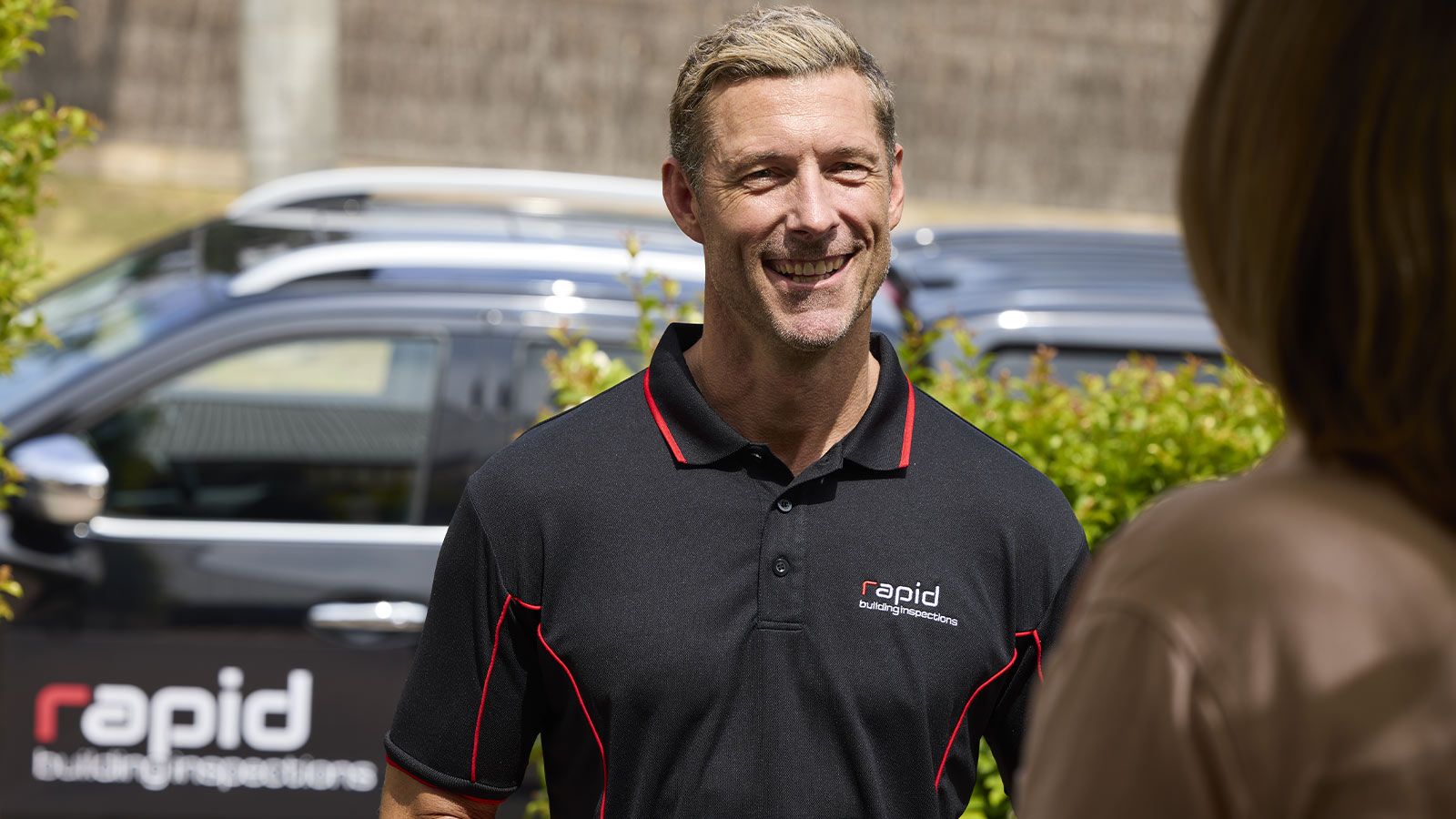 Closeup of a building inspector greeting a customer.