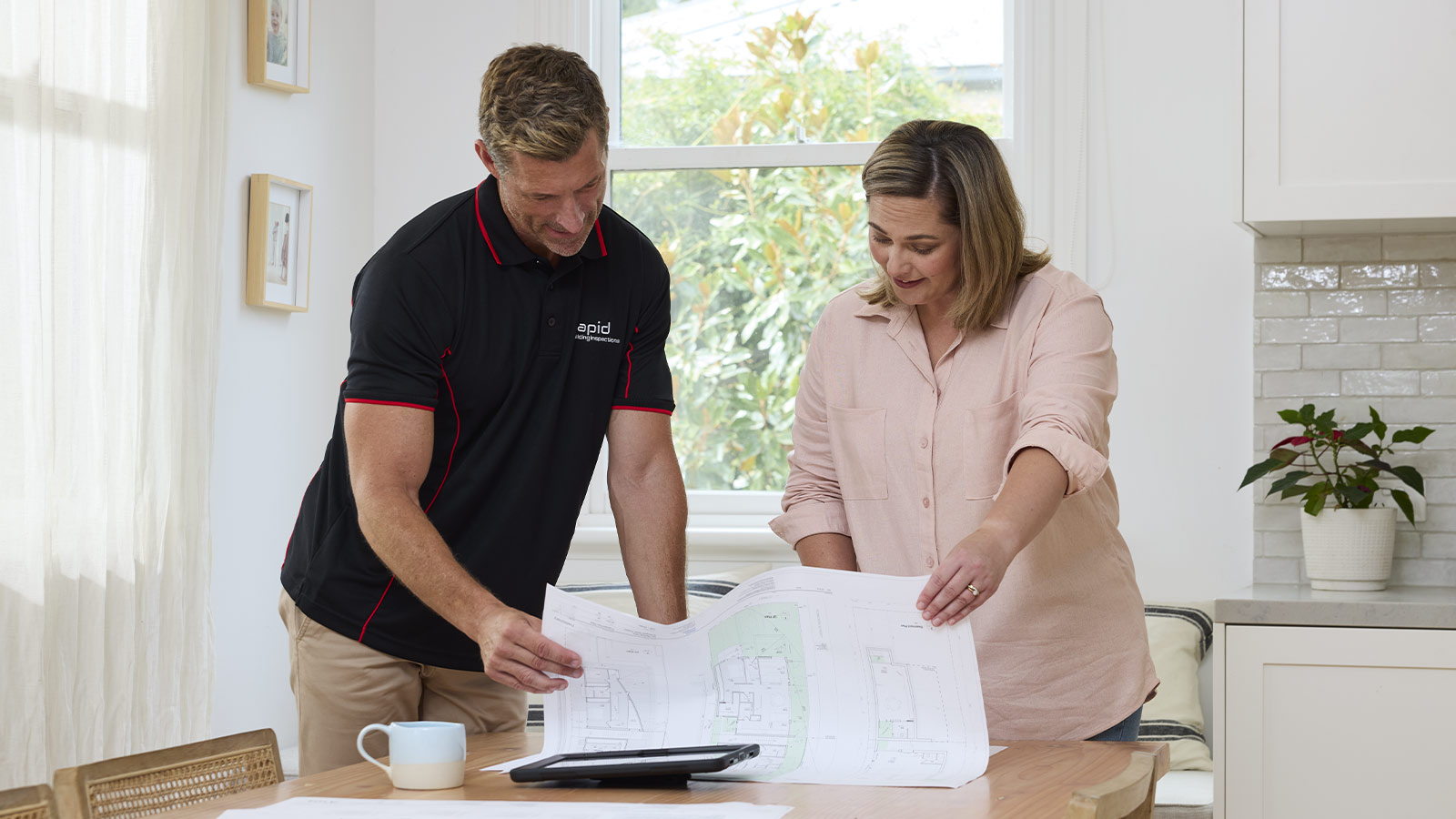 Building inspector and customer discussing house plans.