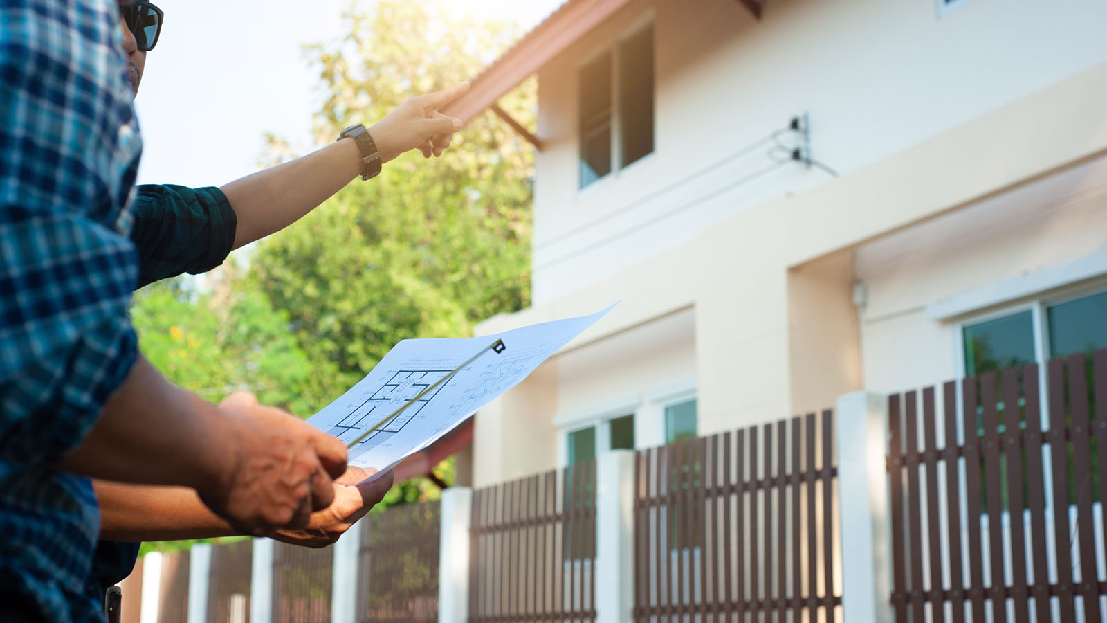 An inspector and contractor reviewing house plans.
