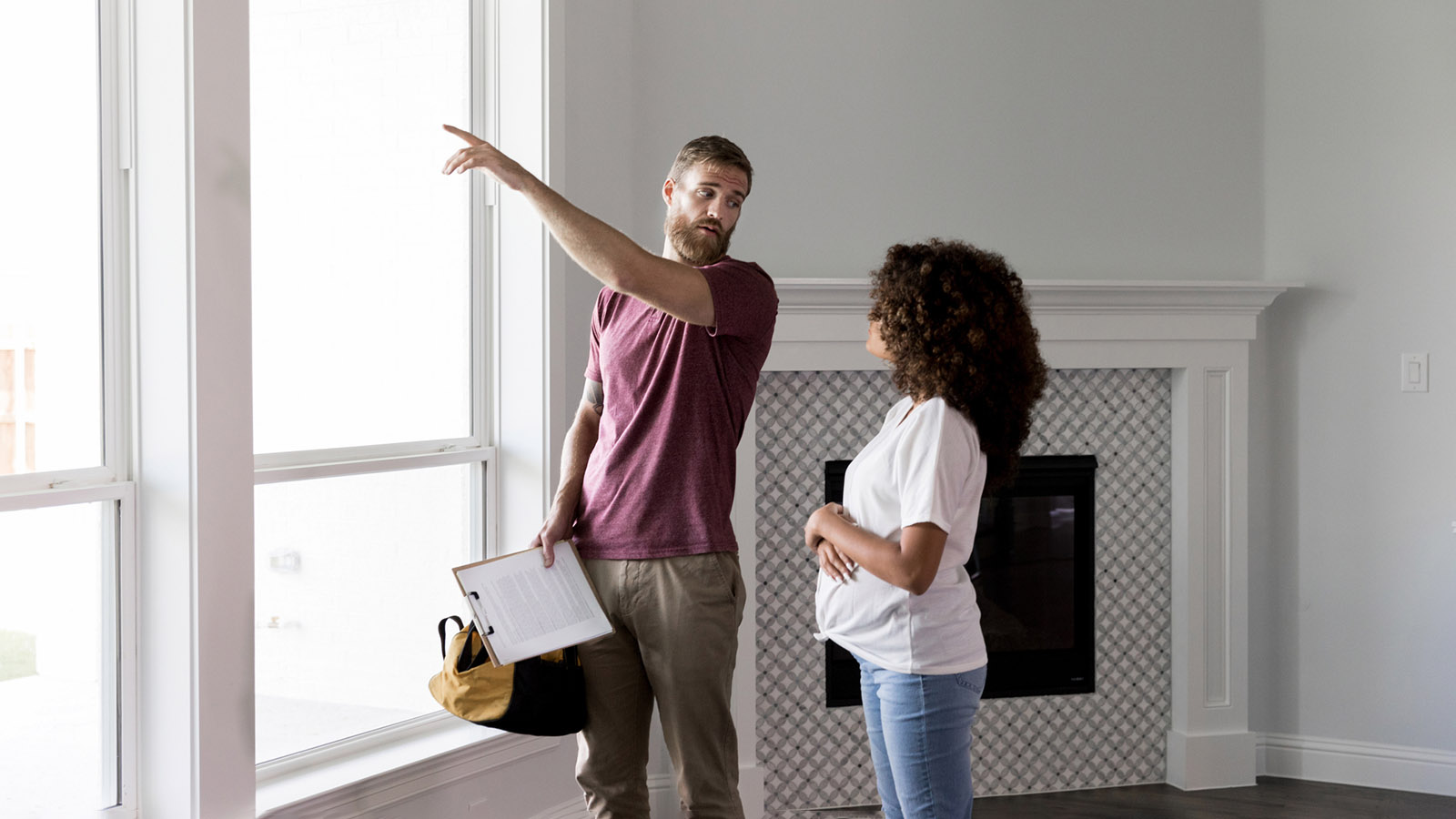 An inspector discussing an issue with the homeowners window.