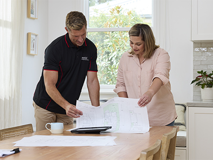 Building inspector and customer discussing house plans.