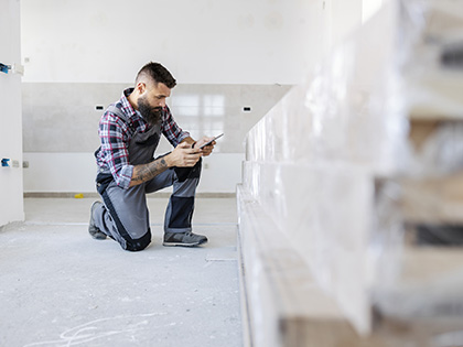 An inspector reviewing construction materials inside a home.