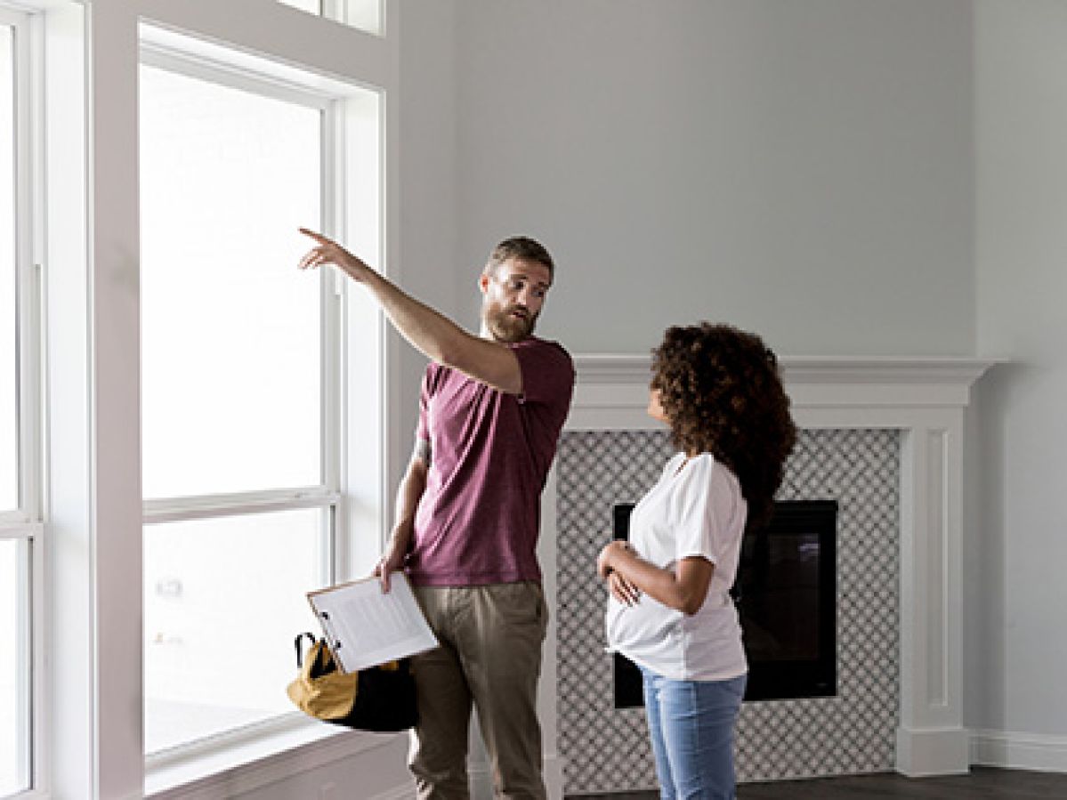 An inspector discussing an issue with the homeowners window.