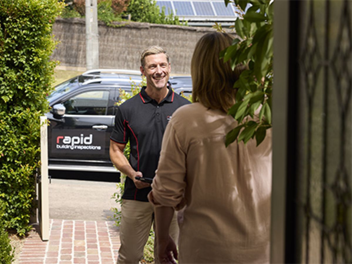 Building inspector arriving at a customers property and smiling.
