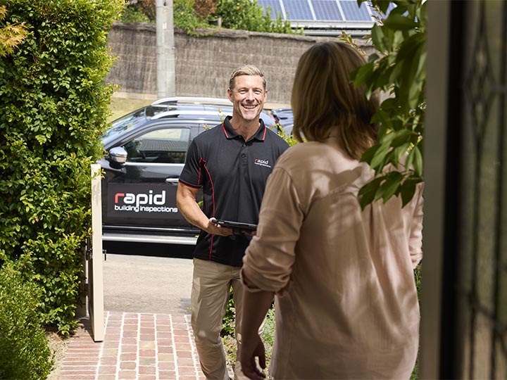 Building inspector meeting the customer at their front door.
