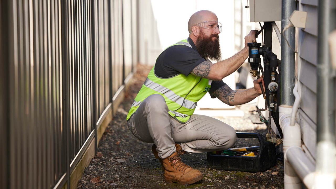 RACV Plumber fixing hotwater system.