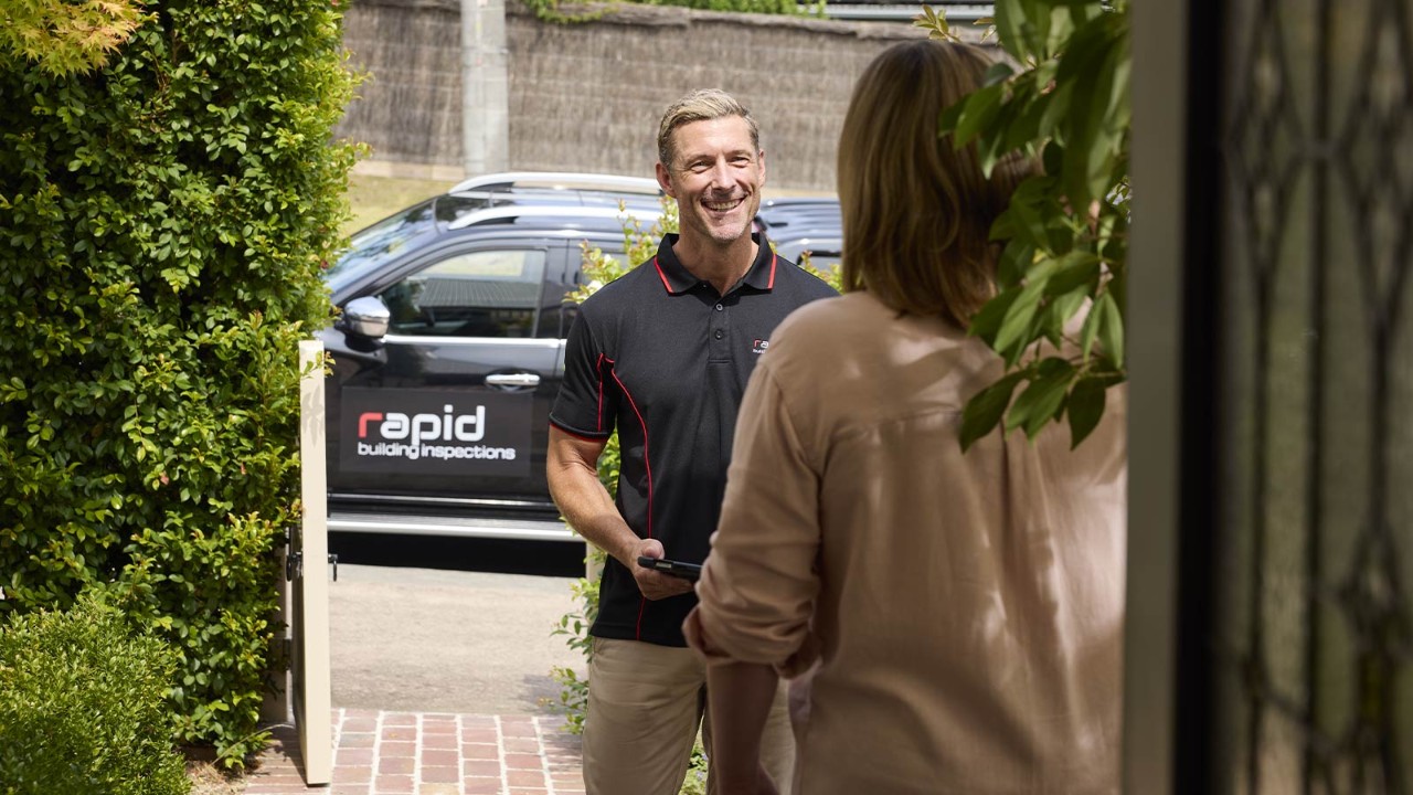 Building inspector arriving at a customers property and smiling.